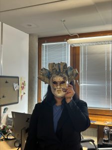 Peiyu holding a ventian carnival mask.